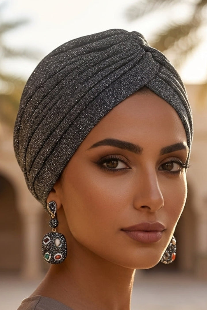 Woman wearing a dark headscarf in an arched architectural setting