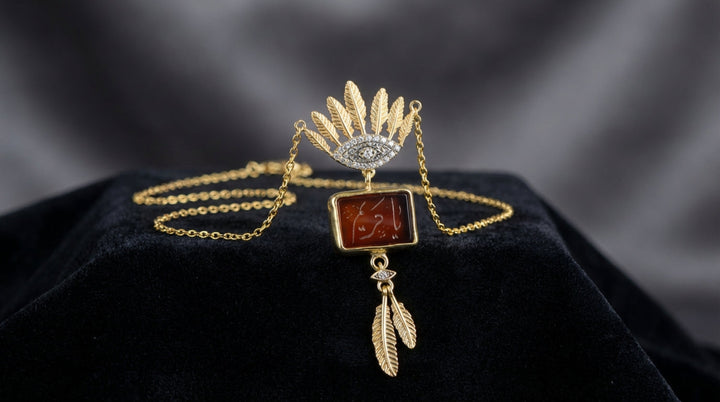 Gold Sterling Silver Hand Engraved Aqeeq 99 Names Necklace on a black velvet surface