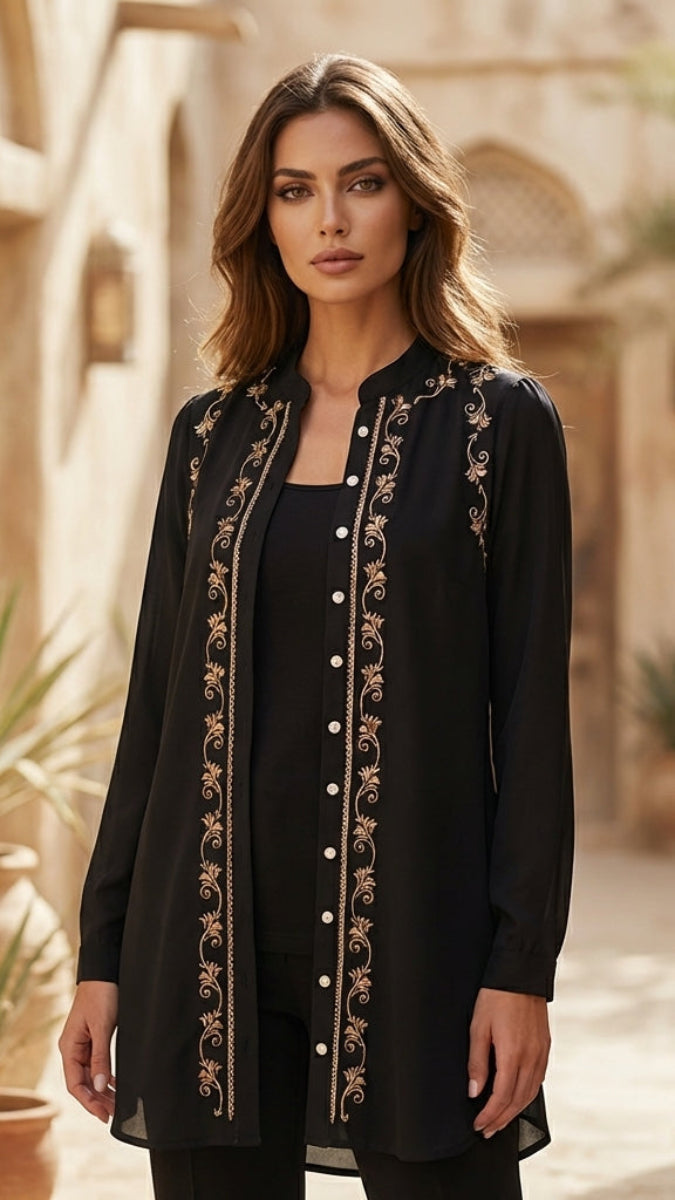 Woman wearing a black embroidered long shirt in an outdoor setting