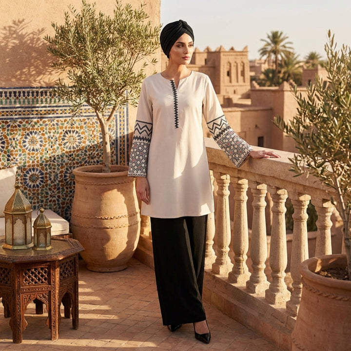 Woman in traditional attire standing on a balcony with decorative plants and tiles.