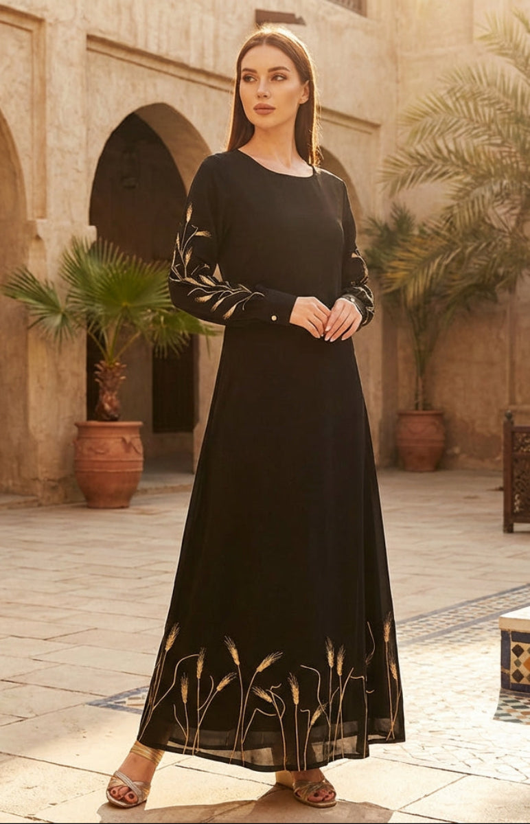 Woman in a black dress standing in a courtyard with arches and potted plants.