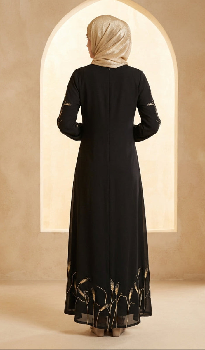 Woman wearing a black dress with gold embroidery in a beige archway.