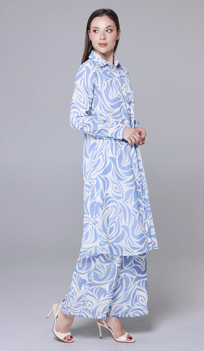 Woman wearing a blue and white patterned dress on a gray background