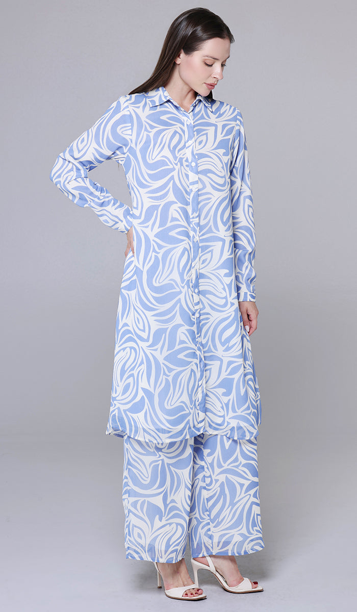 Woman wearing a blue and white patterned outfit on a gray background