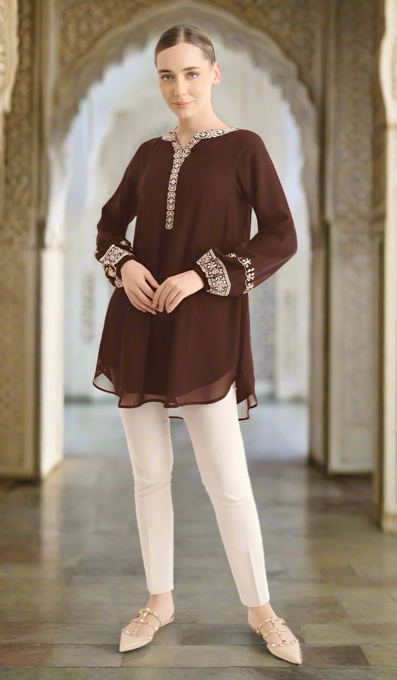Woman in building wearing Amalie tunic in Cocoa. 