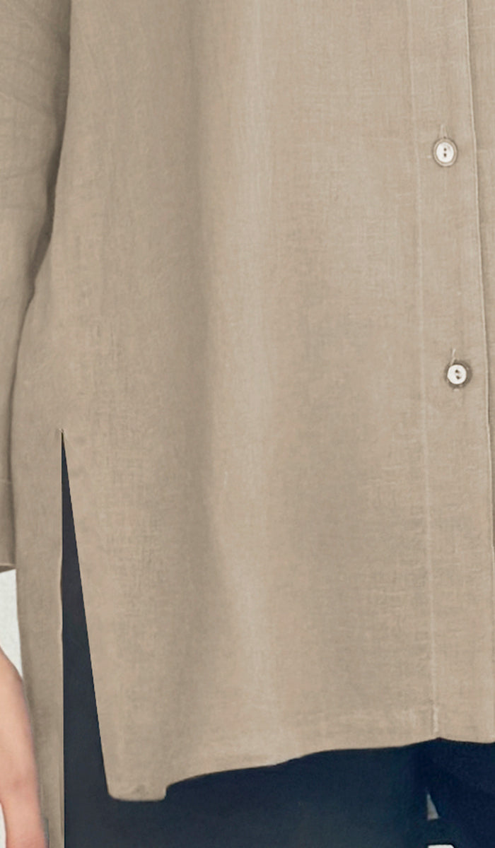 Close-up of a beige shirt with buttons on a blurred background