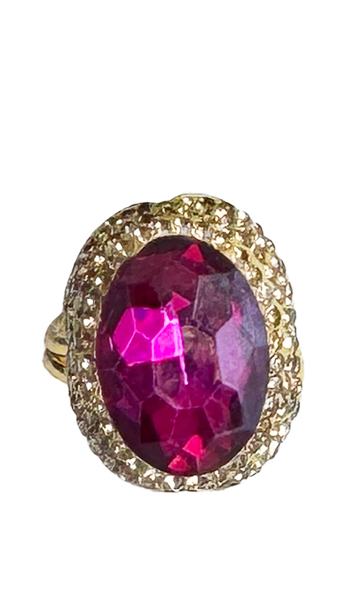 front view of a oval hot pink jewel ring with gold shimmer crystals.