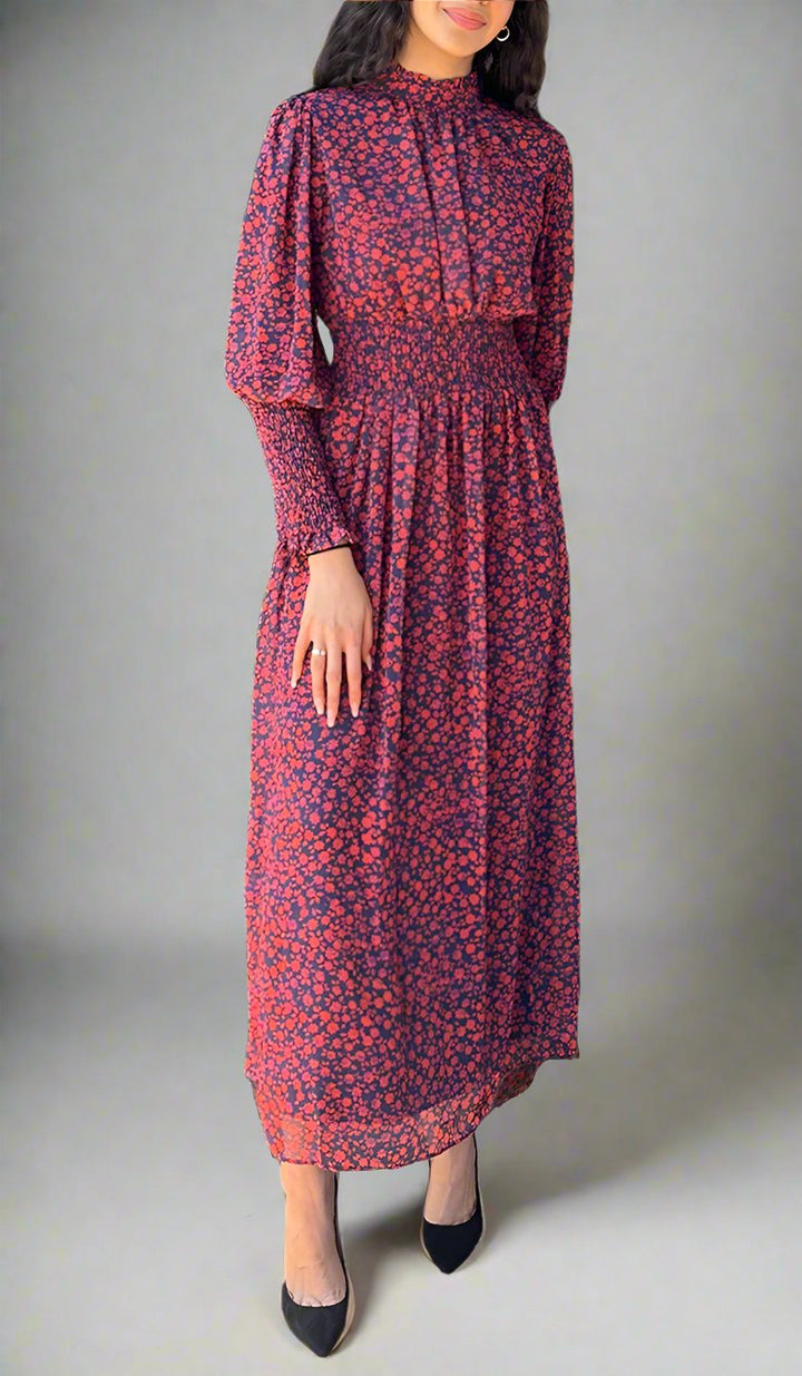 Woman wearing Anisa dress with black heels. 