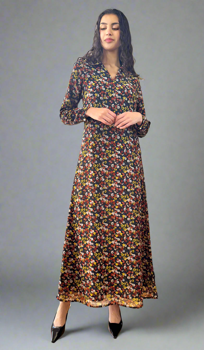 Woman in a floral dress standing in a room with a piano and window.