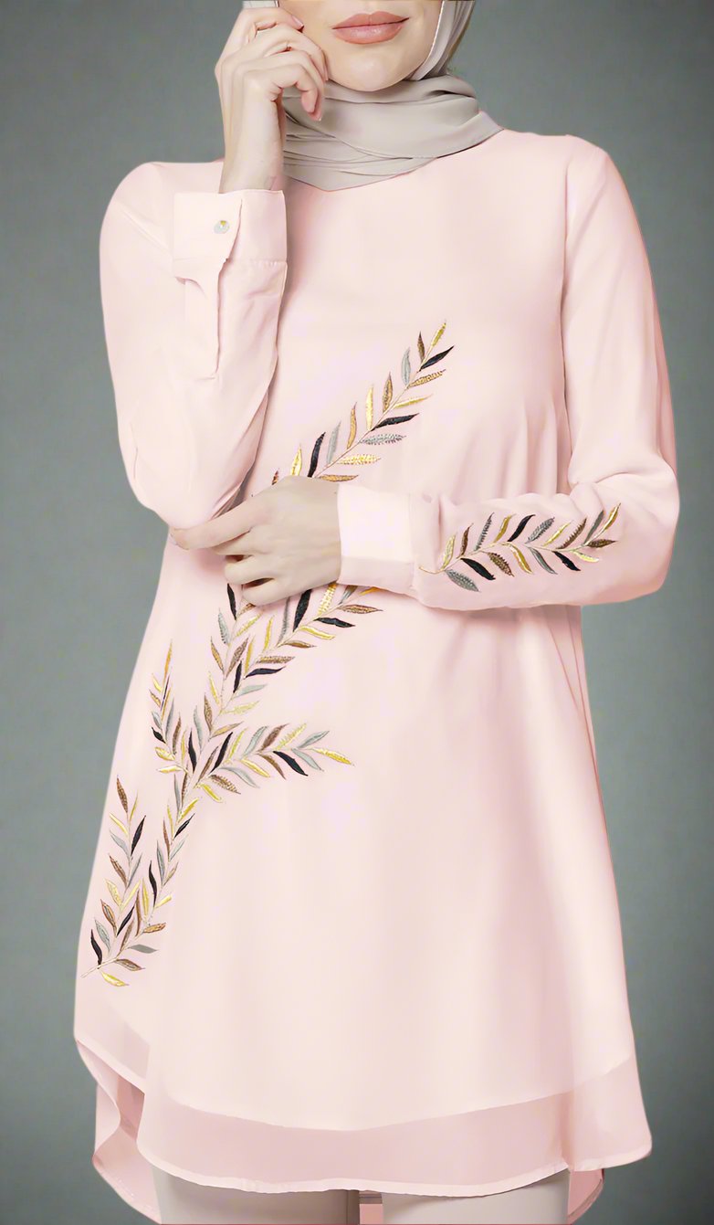 Woman wearing Baraka tunic in Blush Pink. 