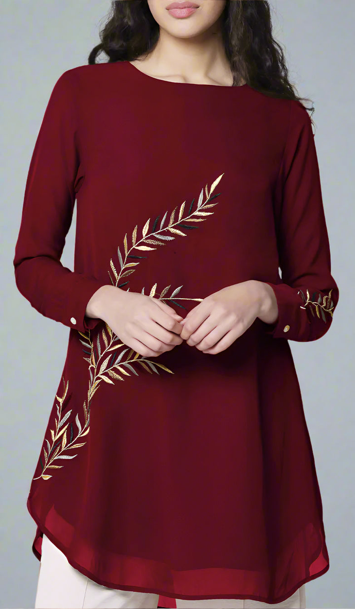 Woman wearing Baraka tunic in Ruby. 