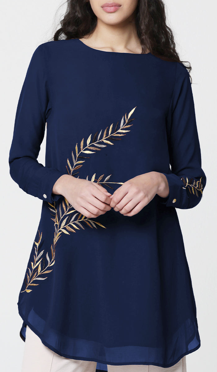 Woman wearing Baraka tunic in Sapphire. 