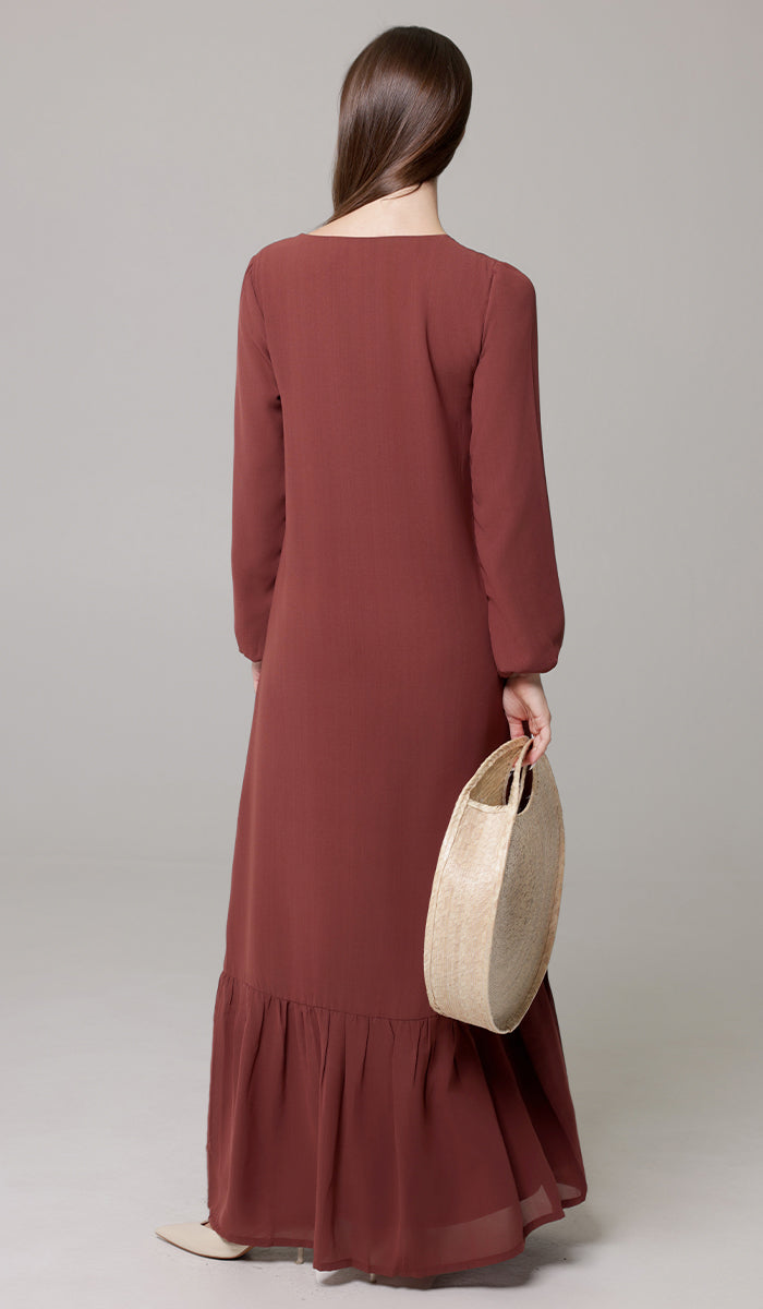 Back view of woman wearing Batool dress in Brick. 
