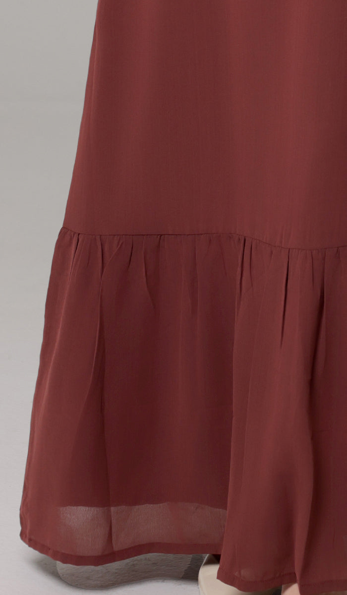 Details of bottom of Batool dress in Brick.