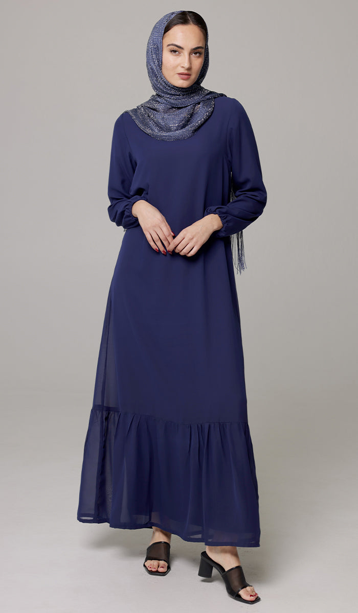 Woman wearing Batool dress in Navy Blue with hijab and sandals. 