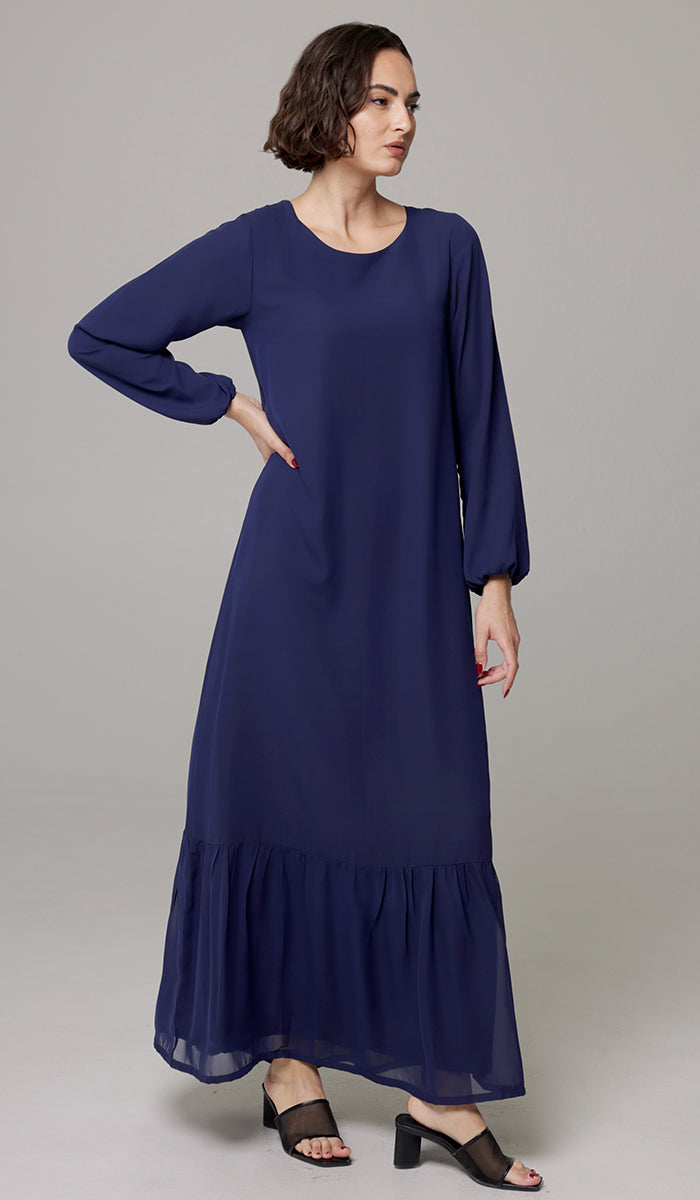Woman wearing Batool dress in Navy Blue with sandals. 