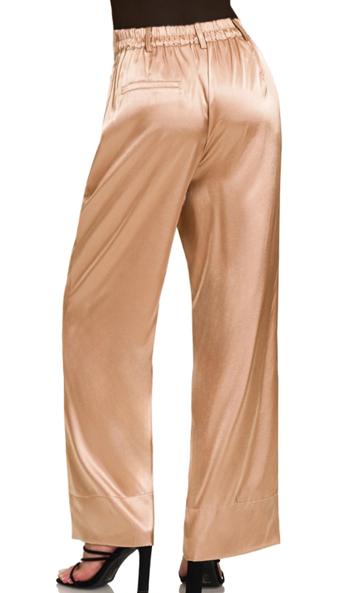Back view of woman wearing Eva pants in Champagne. 