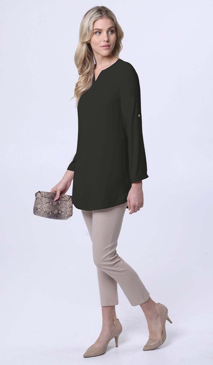Woman wearing Hena tunic in Black with khaki pants, heels, and purse. 