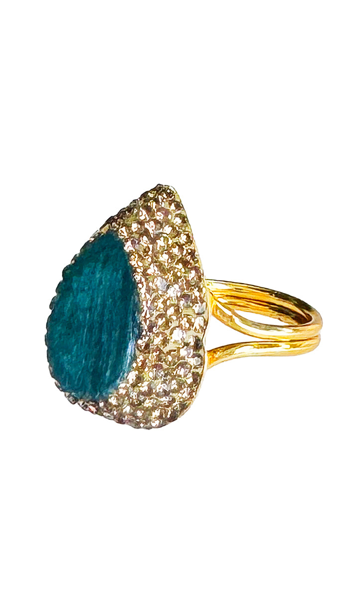 three quarter side view of tear dropped emerald ring.