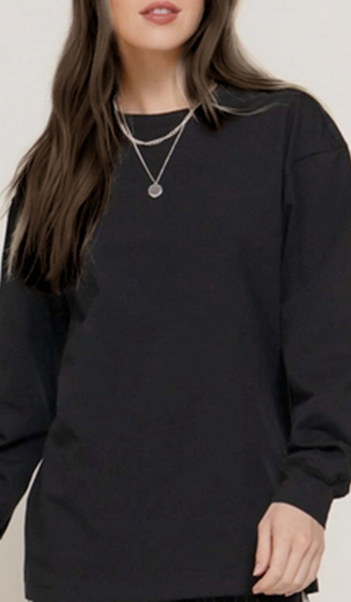 Person wearing a black sweatshirt with a neutral background