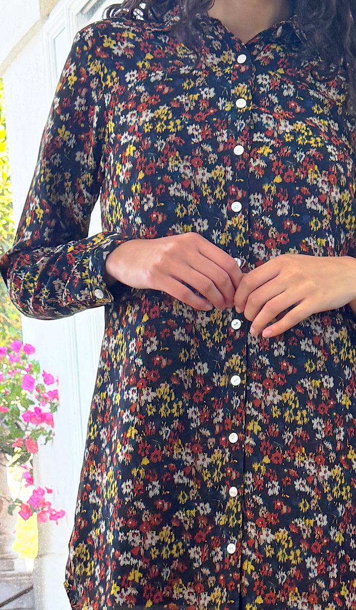 Multicolored floral patterned dress with buttons on a white background