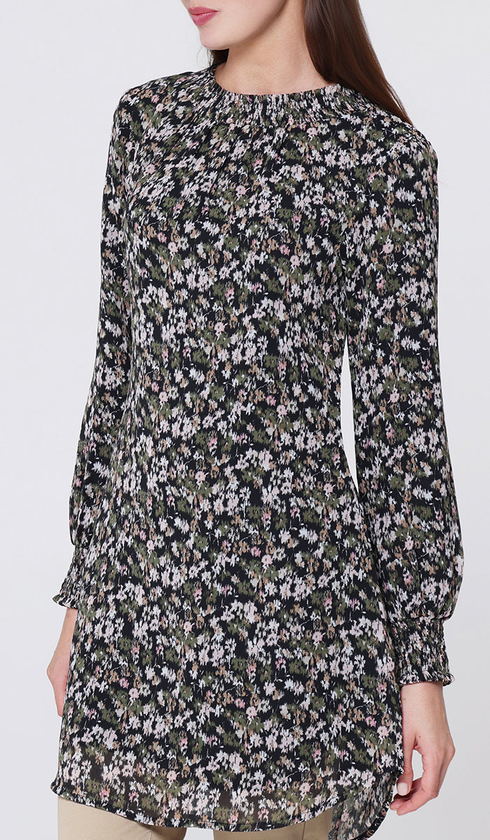 Woman wearing a floral blouse against a white background