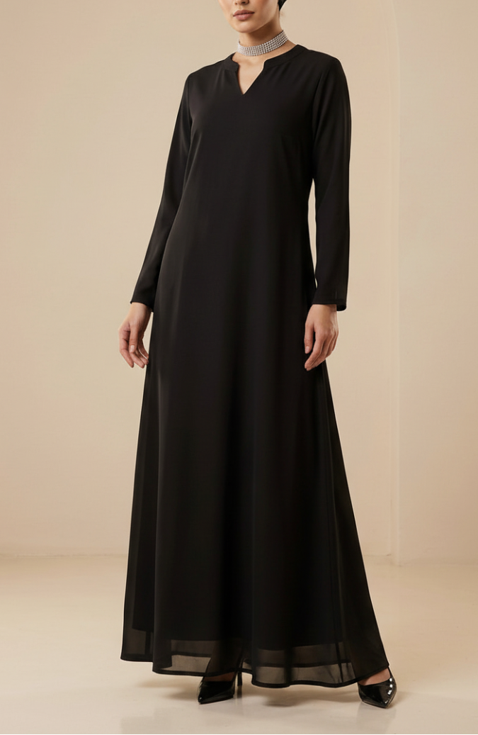 Woman wearing a black long-sleeve dress and headscarf on a beige background