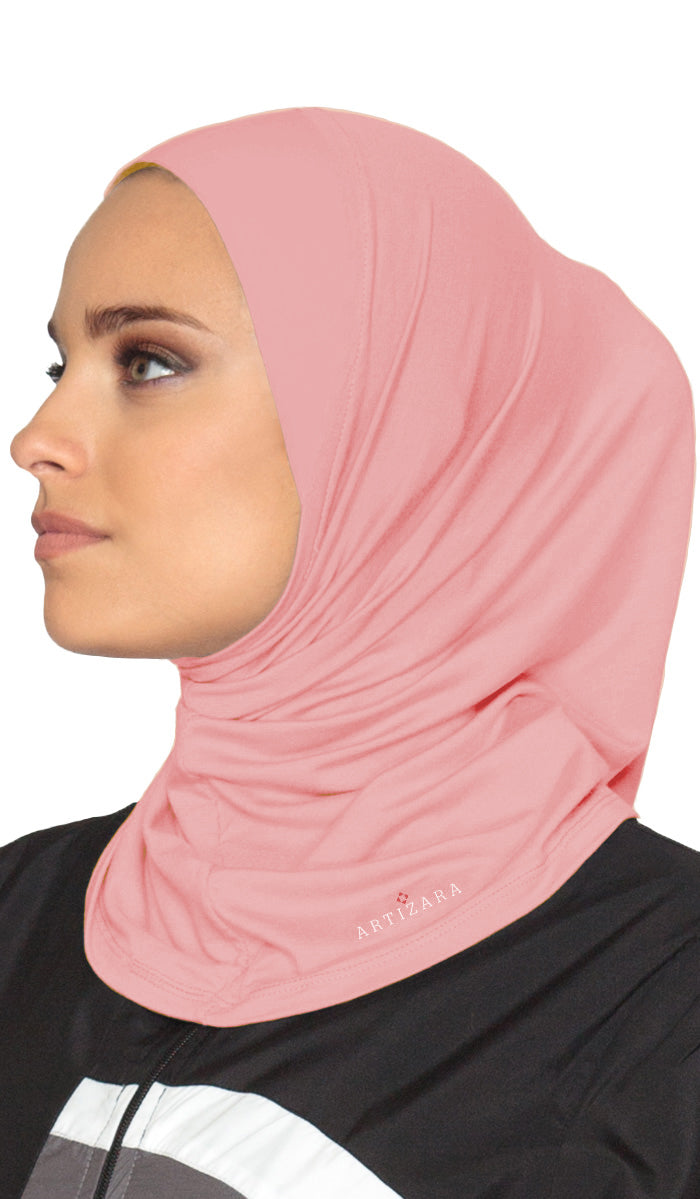 Woman wearing a pink hijab with a visible brand logo on a white background
