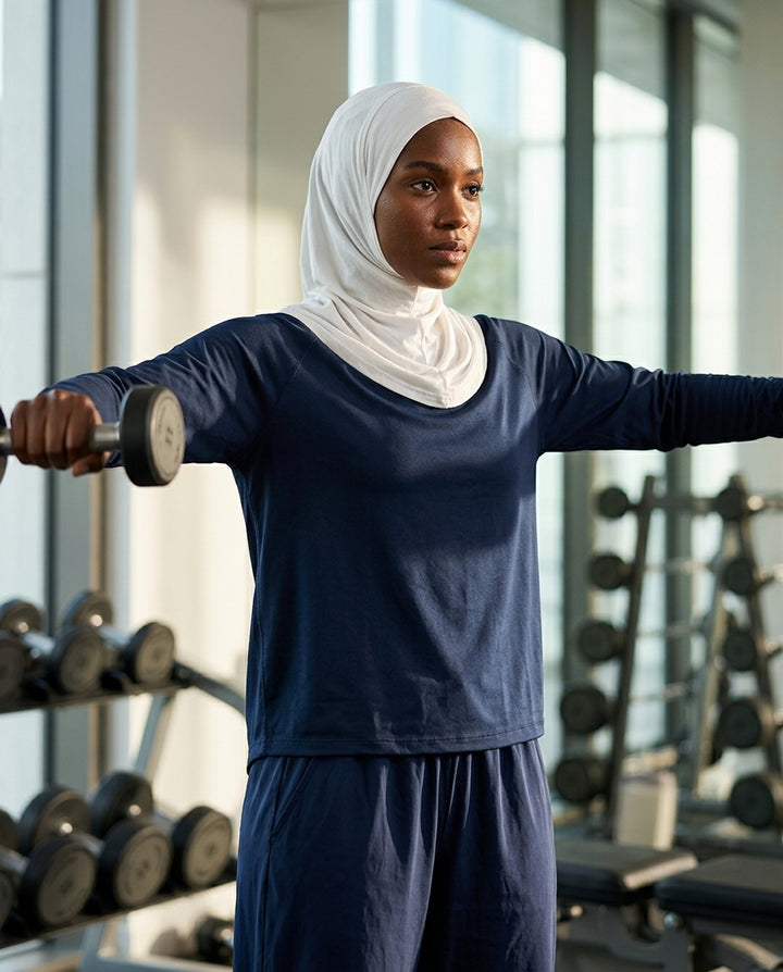 Woman exercising with dumbbells in a gym setting