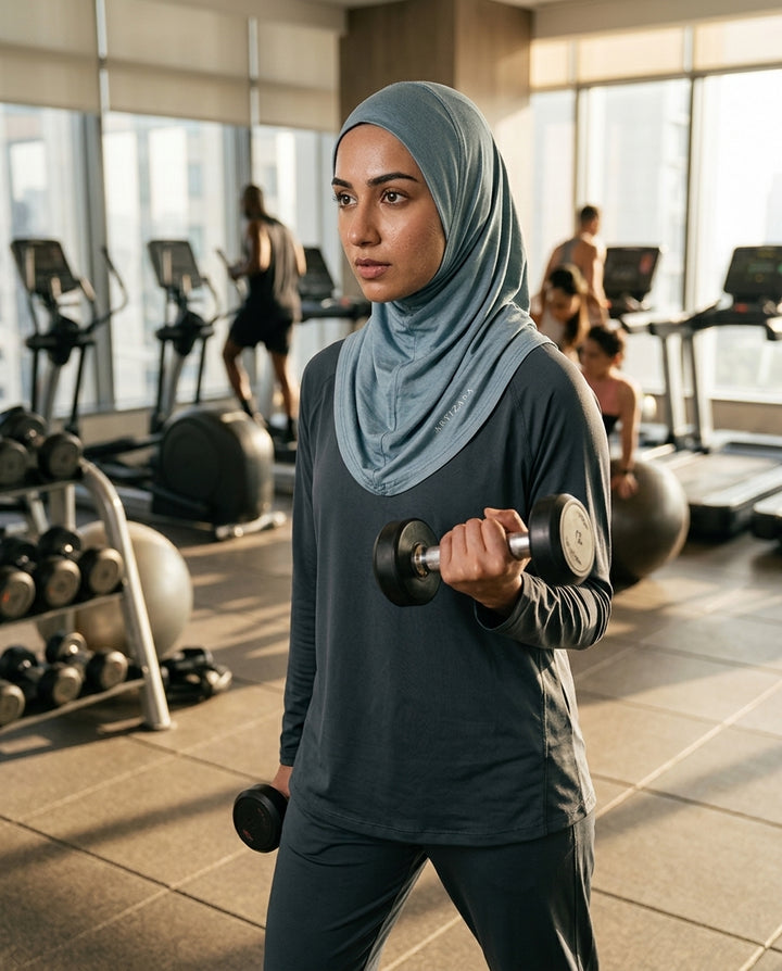 Woman exercising with dumbbells in a gym setting