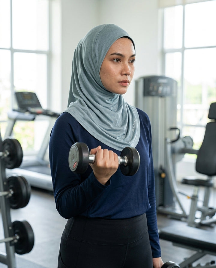 Woman lifting a dumbbell in a gym setting