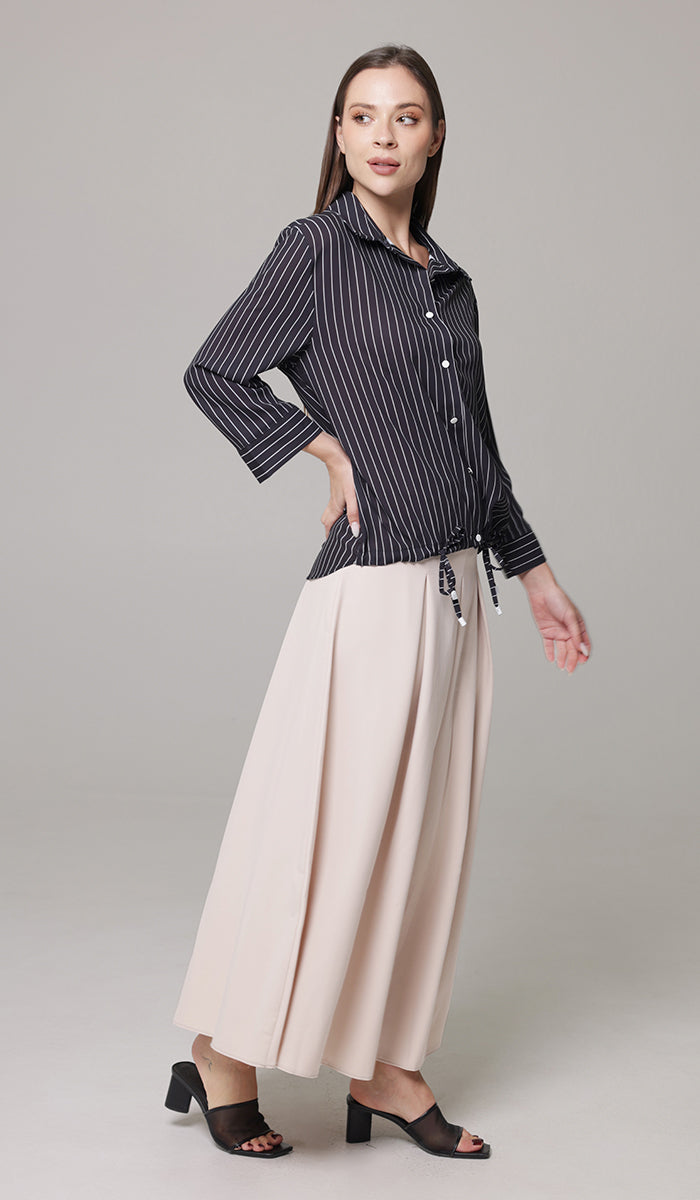 Side view of woman wearing Mia skirt in Blush with Parvin tunic in Black and White. 