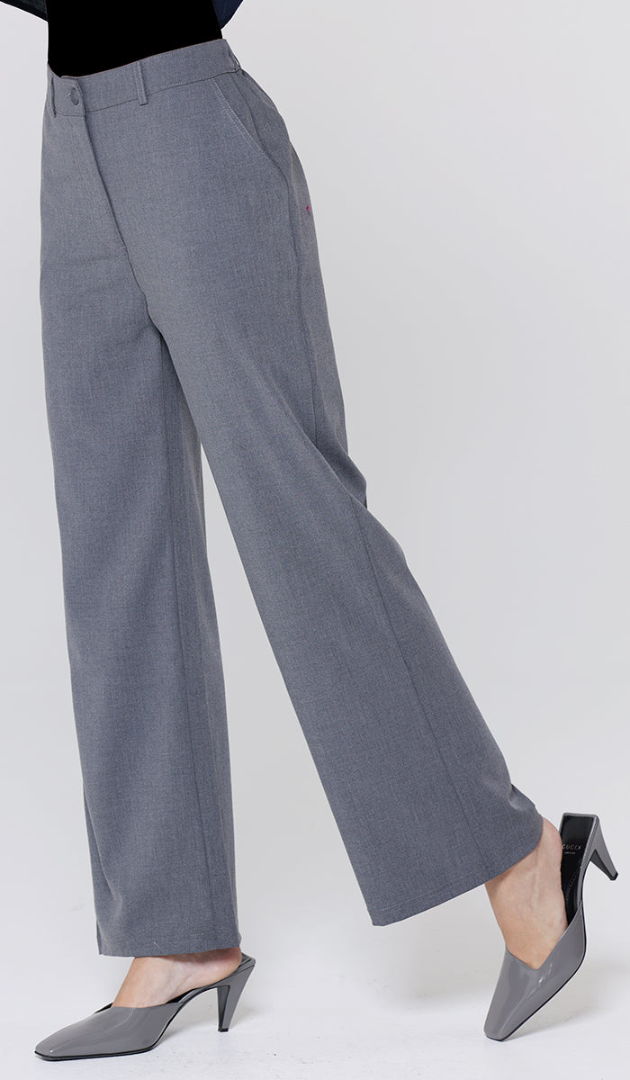 Gray pants worn by a person on a white background
