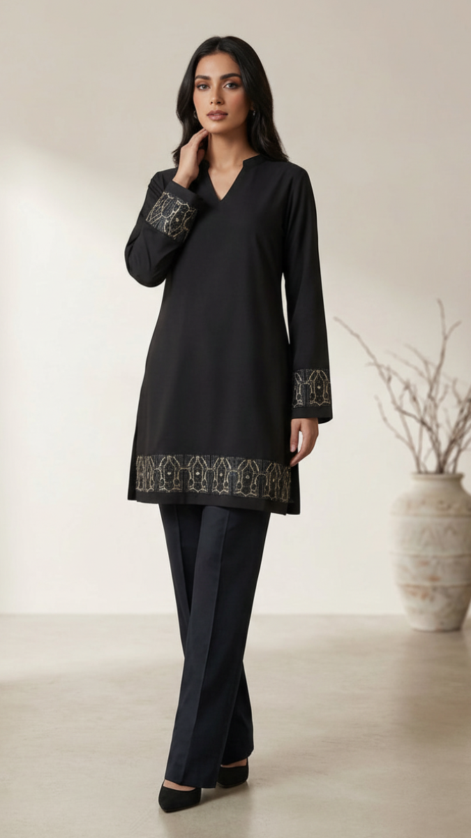 Woman wearing a black outfit with lace details in a minimalistic setting