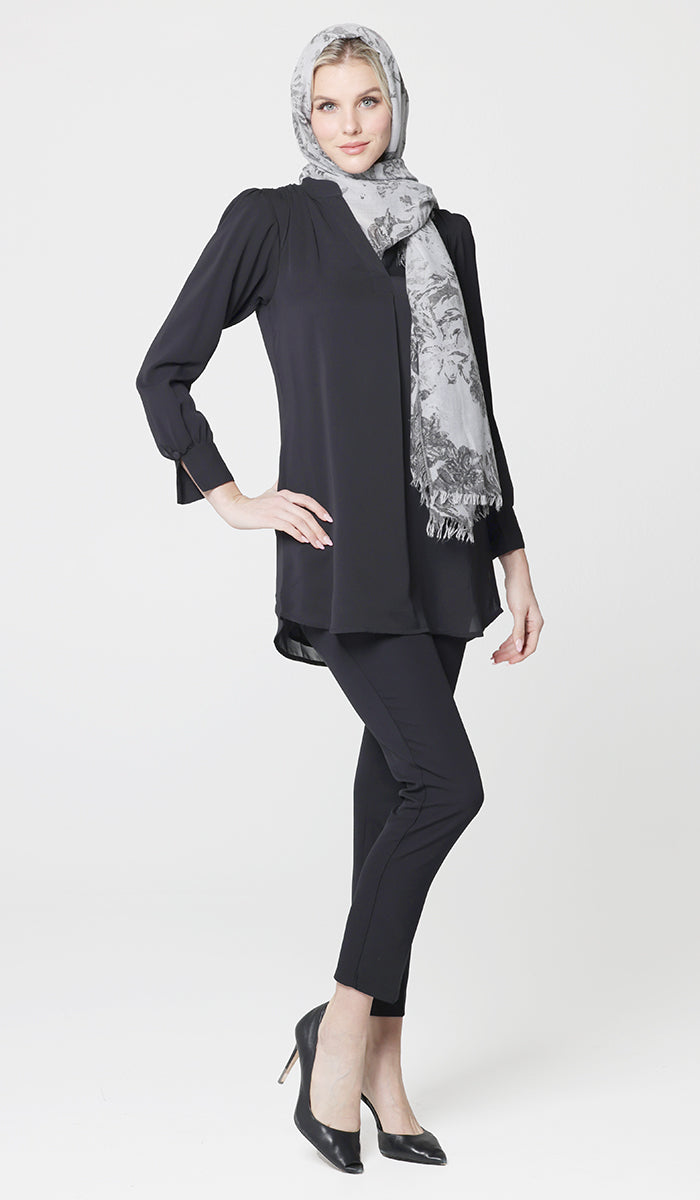Woman wearing cotton hijab in Gray with Shaina tunic in Black with black pants and heels. 
