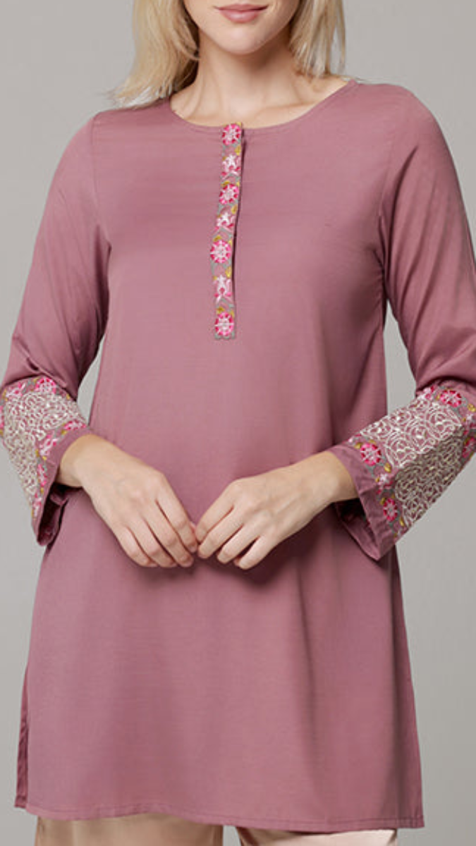 Mauve tunic with floral embroidery on a plain background