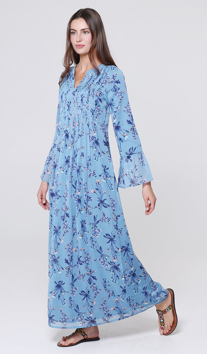 Woman wearing a blue floral dress on a white background