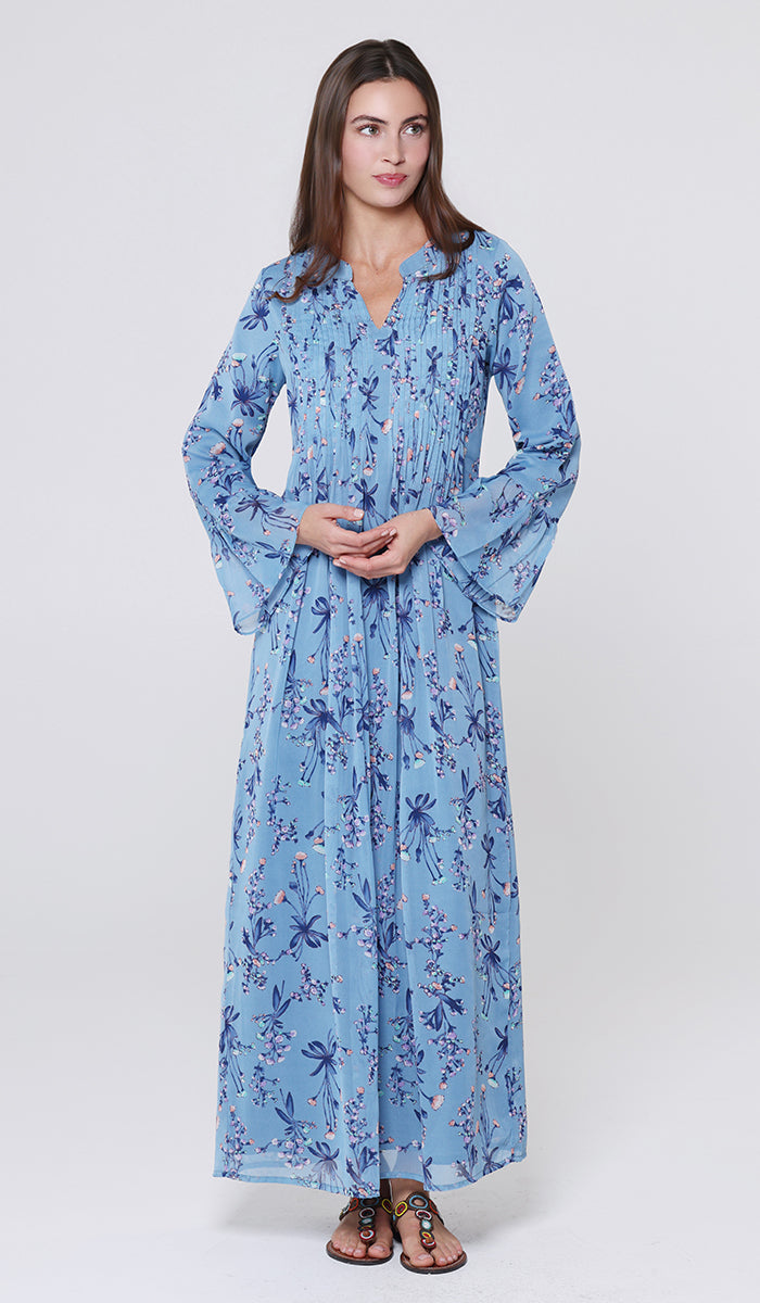Woman wearing a blue floral dress on a white background