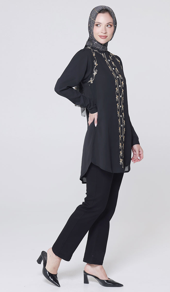 Woman wearing a black outfit with lace details on a white background