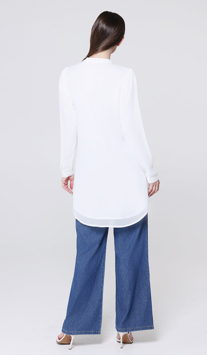 Person wearing a white shirt and blue jeans on a white background