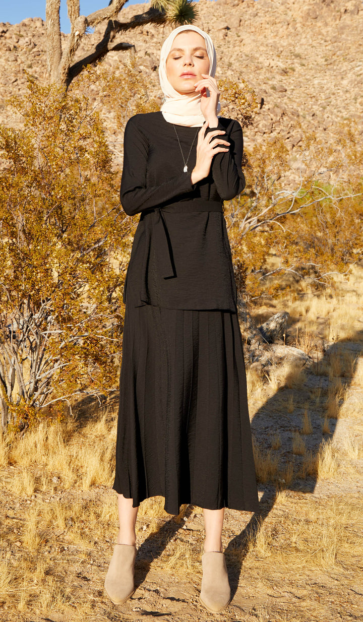 Woman outside wearing Amani Softly Pleated Long Skirt in Black.
