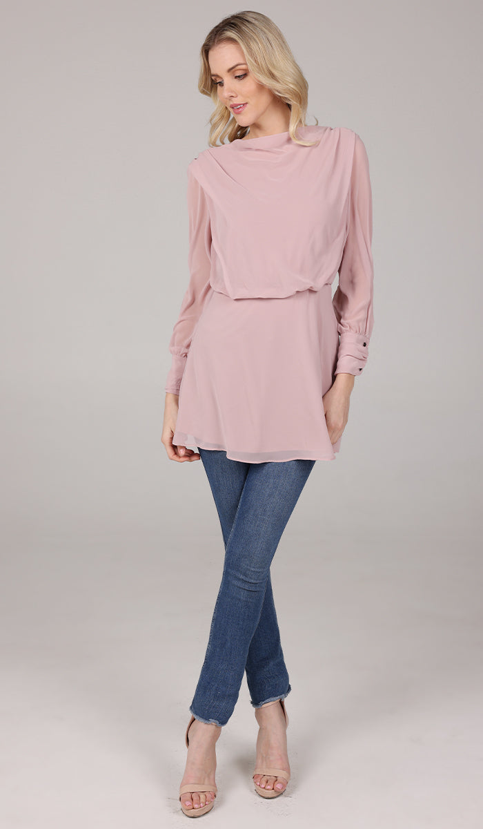 Woman looking down wearing Myra chiffon tunic in Tearose with jeans and heels. 