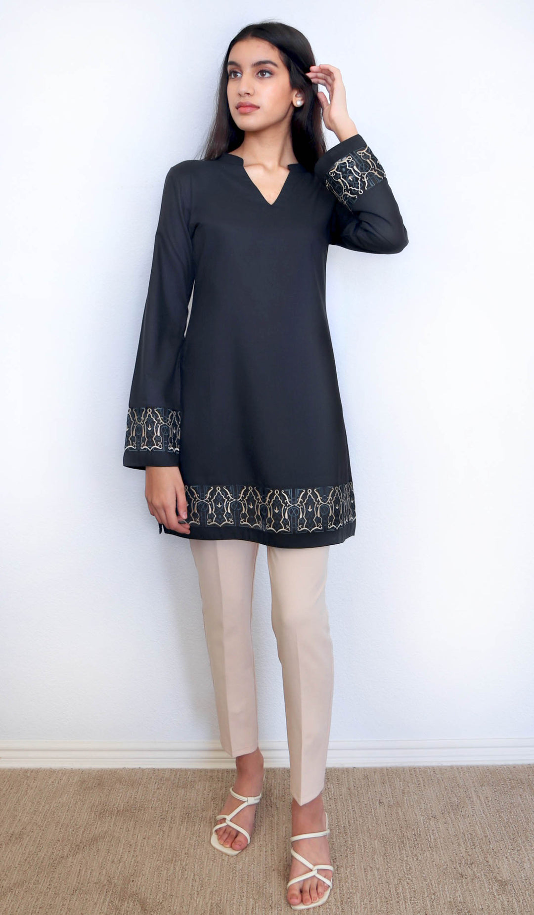 Woman wearing embroidered Selma tunic in Black. 