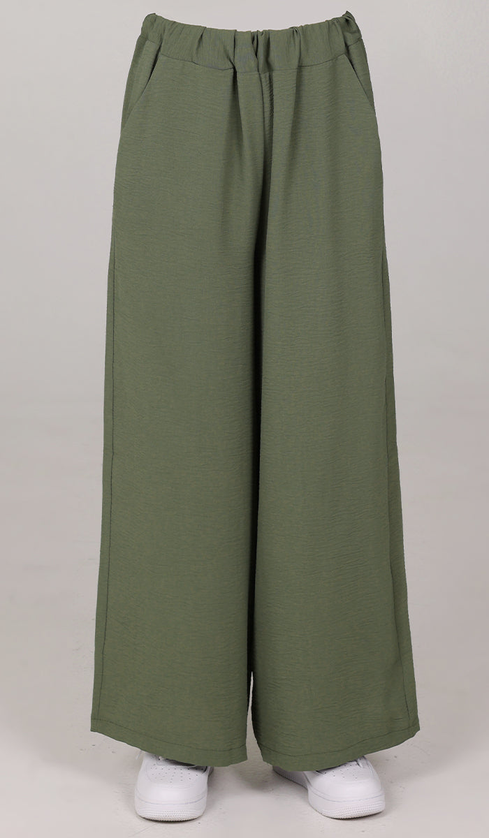 Front view of woman wearing Tina pants in Olive. 